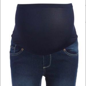 Dark distressed denim roll cuff over belly jeans